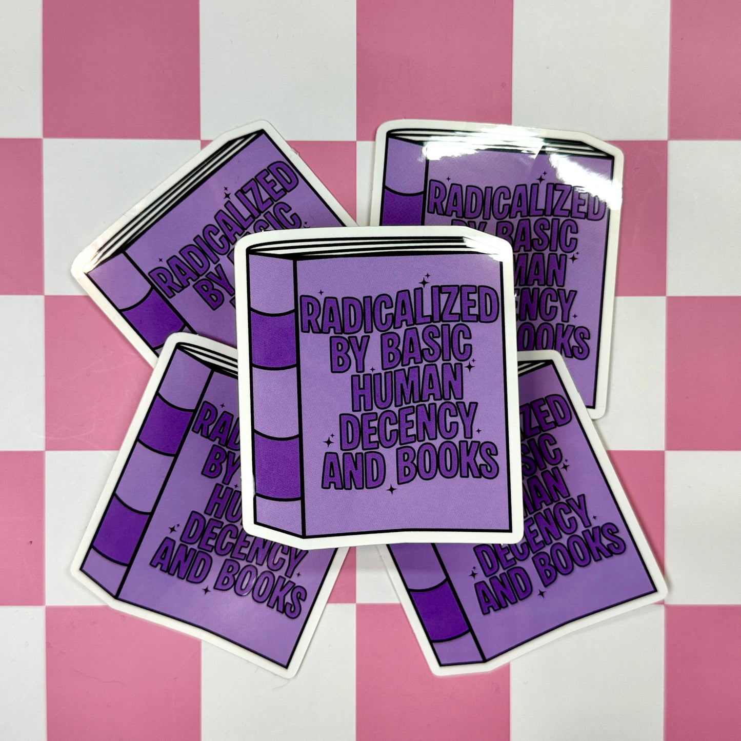 Purple book-shaped stickers with text on a pink and white checkered background